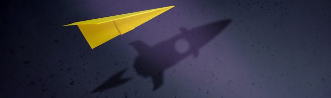 Start-up Company and Motivation in Business Concept. Paper Planes Flying with Shadow of Rocket over the Wall