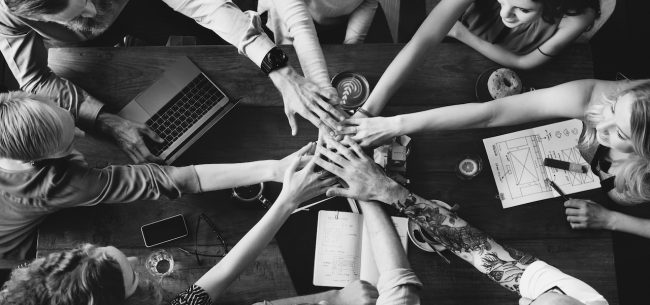 Group of diverse people with joining hands teamwork